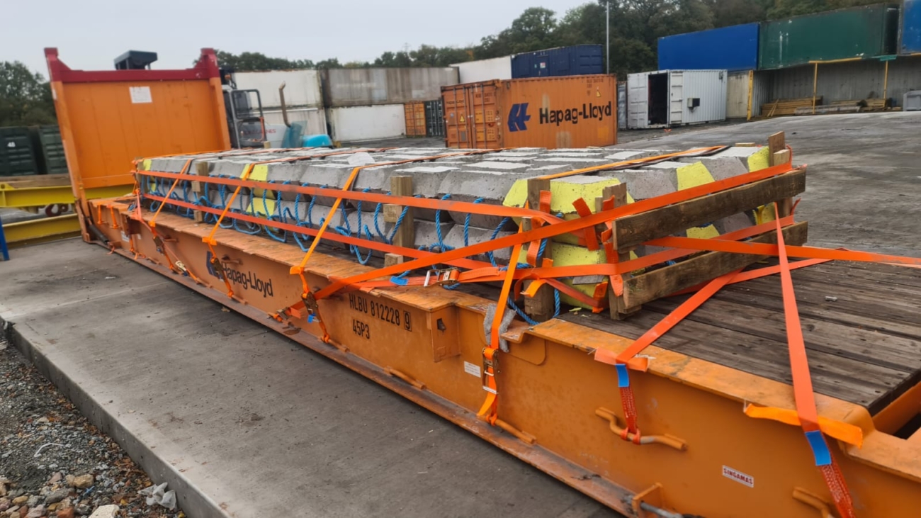 OOG concrete bridge section secured to 40ft flat rack for shipment to Dakar Senegal